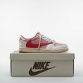 Kicks and The Drip Nike Air Jordan low-top sneakers in pink, white, and red with a signature reverse swoosh on a box.